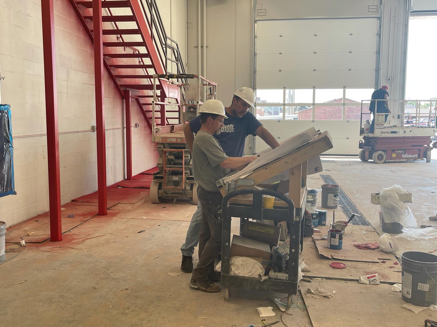 People talking over architectural plans