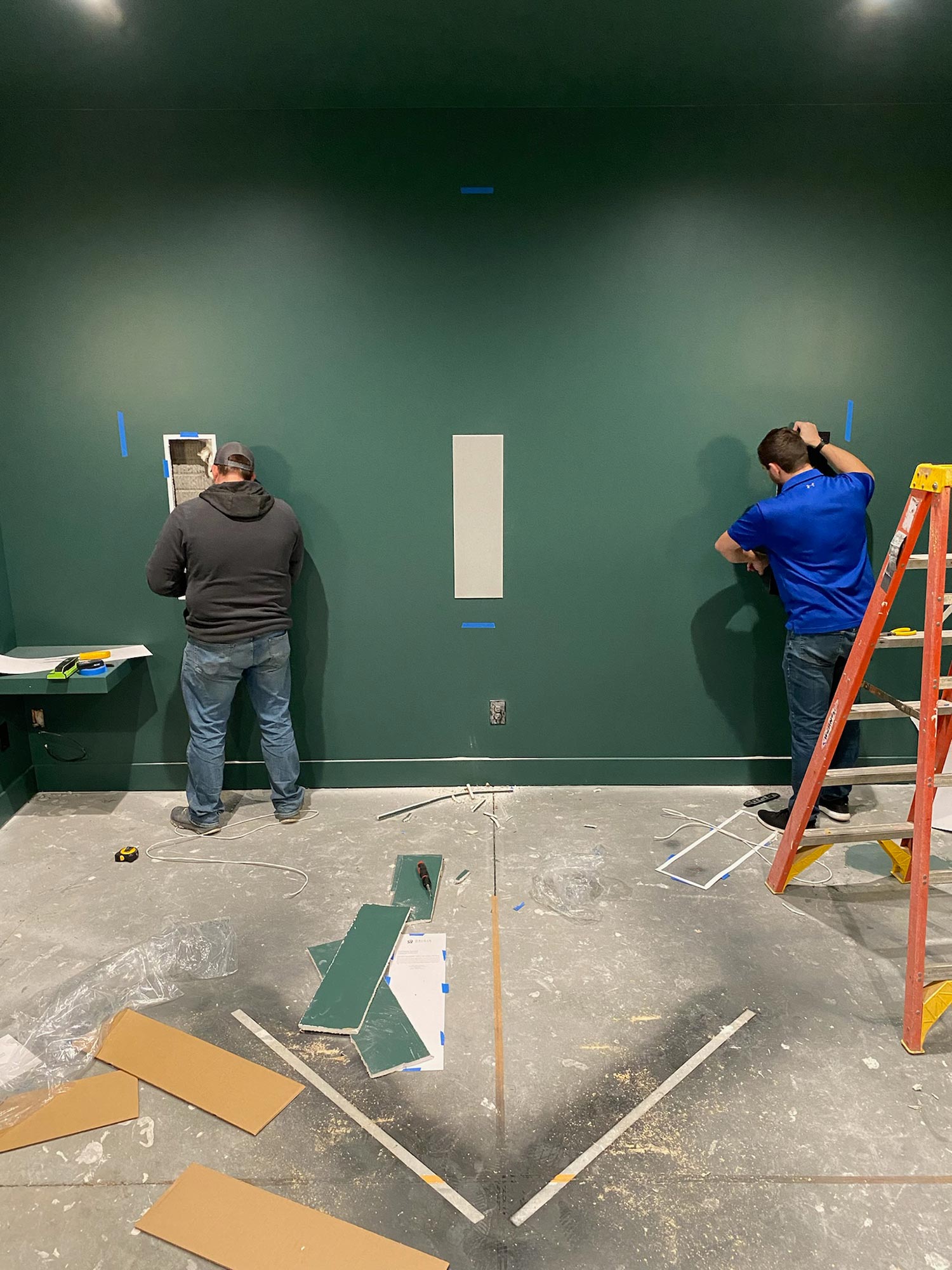 Men installing wall panels