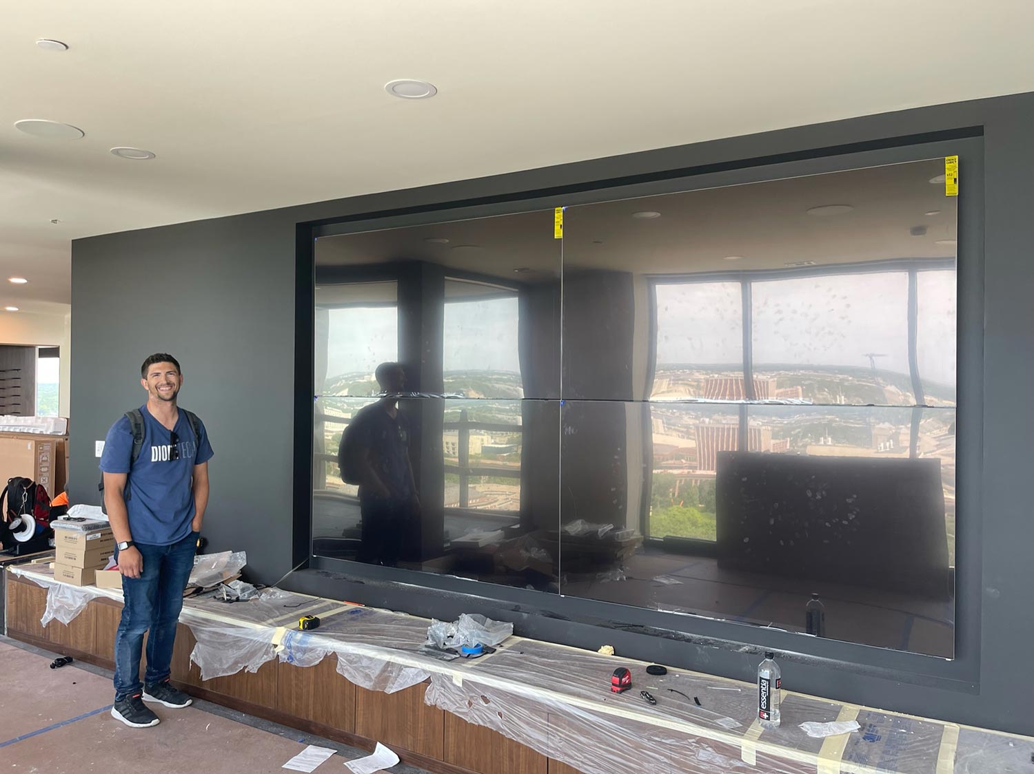 Man smiling after installing video wall