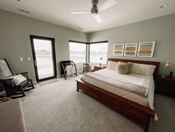Bedroom with opened shades and ceiling speakers