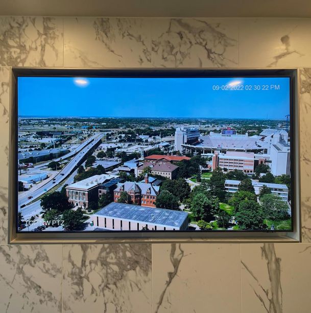 TV hanging in marble wall