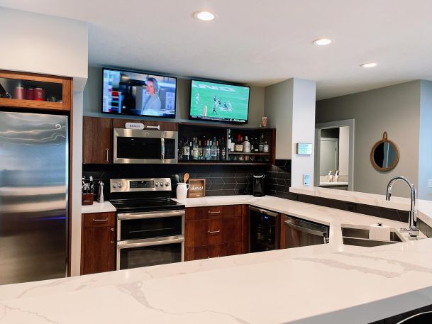 2 TVs in a kitchen