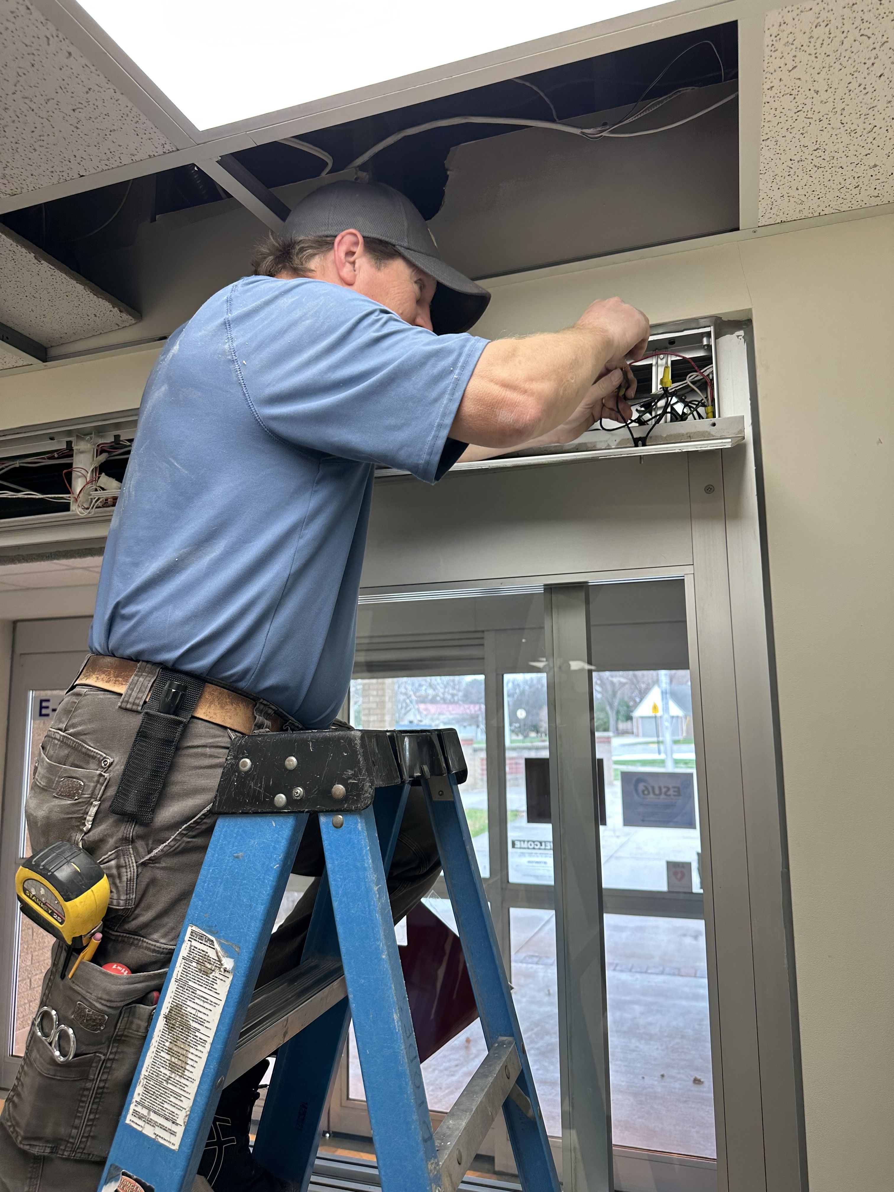 man wiring door access control system