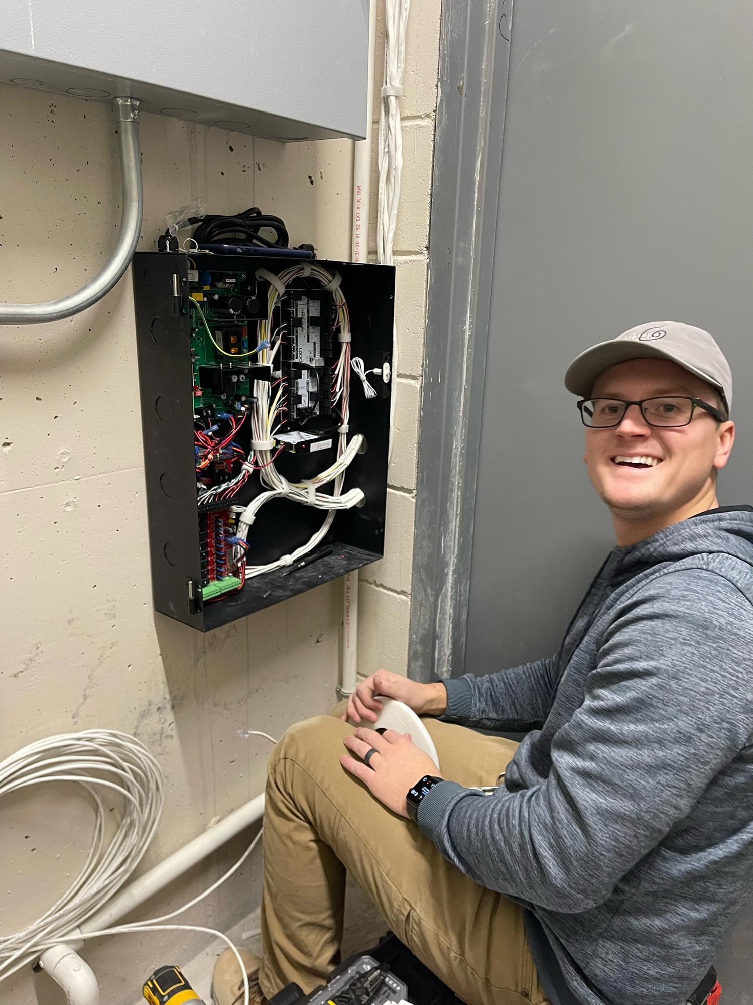 Man smiling with an electrical board